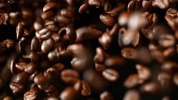 istock Coffee beans flying in the air, macro photo 1166682564