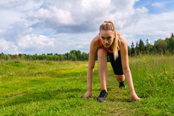 istock young woman in low start position before jogging in the park 1166682801