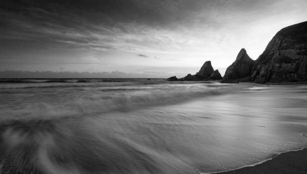 istock Stunning black adn white sunset landscape image of Westcombe Beach in Devon England 1166682910