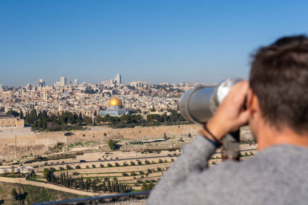 istock Man watching the Old City of Jerusalem with a binocular 1166684183