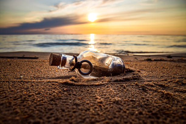 istock Message in the bottle against the Sun setting down 1166685191