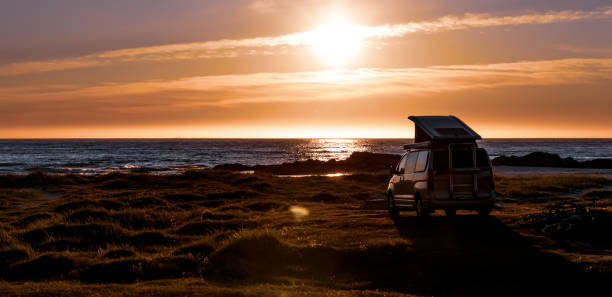 istock Camping car minivan on the beach at sunset Lofoten beach. 1166685317