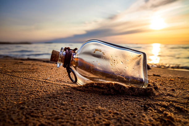 istock Message in the bottle against the Sun setting down 1166685361