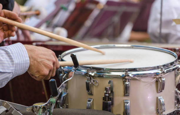istock male musician drummer hands with drumsticks and drum close up 1166686345