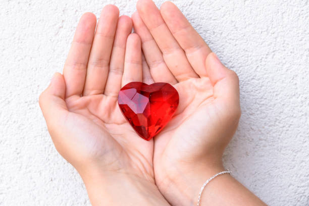 istock woman hands holds red heart. 1166686427