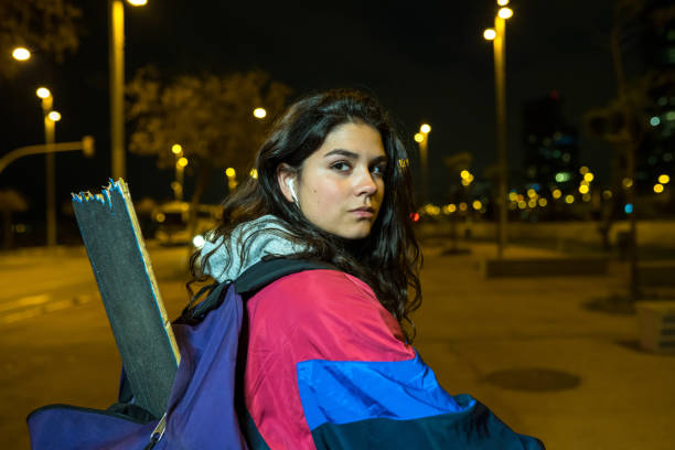 istock Young girl carrying her broken skateboard after an accident 1166687341