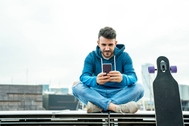 istock Casual man sitting and using his smart phone 1166689110