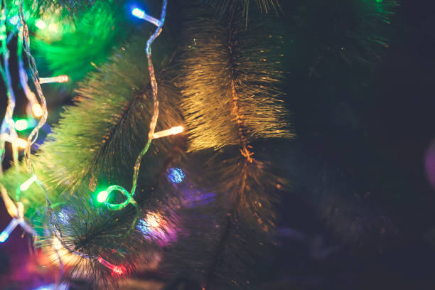 istock Close-up view of Christmas tree decorated with garland lights 1166689331