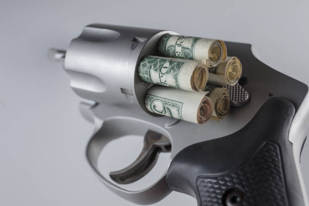 istock Gun and cash 1166692558