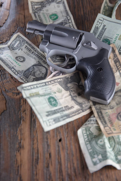 istock Gun and cash 1166692567
