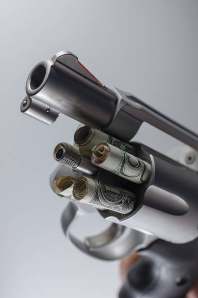 istock Gun and cash 1166692572