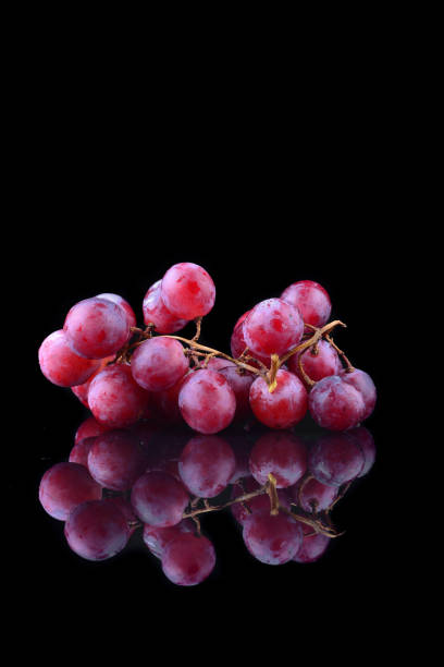 istock bunch of red grapes isolated on black background 1166693578