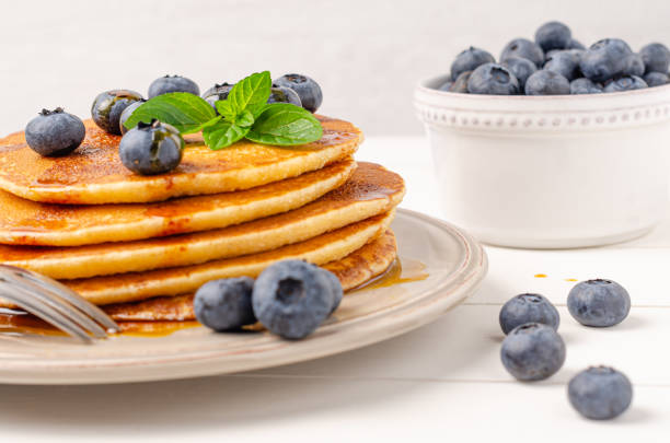 istock Stack of pancakes with fresh blueberry and caramel syrup. Top view 1166700379