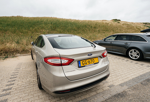 Overveen, Netherlands - Aug 16, 2018: Rear view of new Ford Mondeo Parked on a beach park space in Netherlands on a cloudy day