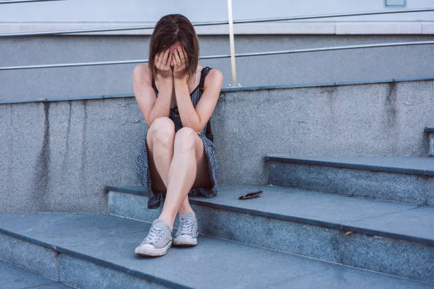istock Young woman crying alone 1166704816