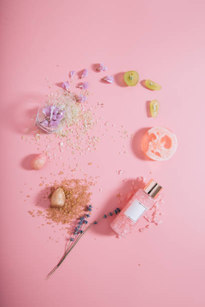 Creative flat lay top view bottles mock up and vase on pastel millennial pink paper background copy space. Template for text lettering blogging