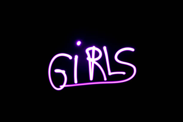 Light effect with lightpainting girly. Word "girls" written with a pink led lamp during a lightpainting session at night. Symbol of girl power. long shutter speed stock pictures, royalty-free photos & images