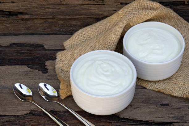 istock Yogurt  In white glass wood background from top view. 1166707898