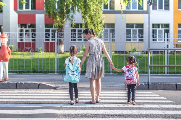 istock Back to school education concept with girl kids, elementary students, carrying backpacks going to class 1166707978