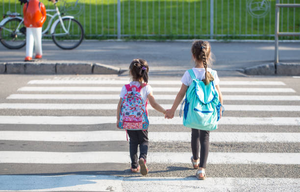 istock Back to school education concept with girl kids, elementary students, carrying backpacks going to class 1166708069