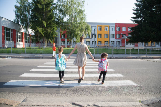 istock Back to school education concept with girl kids, elementary students, carrying backpacks going to class 1166708086