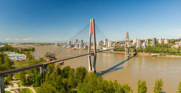 Surrey, Vancouver Aerial panoramic view of Skytrain Bridge over the Fraser River. Taken in Surrey, Greater Vancouver, British Columbia, Canada. new westminster stock pictures, royalty-free photos & images
