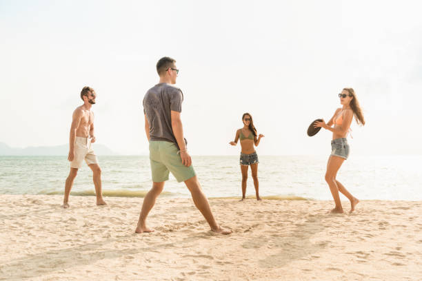 istock Group of friends playing gliding disc at the beach 1166716407