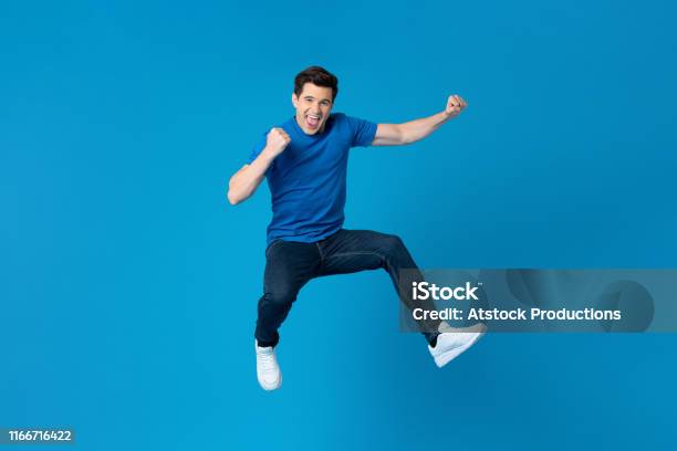 American Man Jumping And Enyoying His Success Stock Photo - Download Image Now - Men, Jumping, Happiness