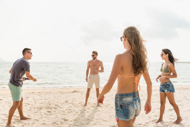 istock Group of friends enjoying playing beach game together 1166716532