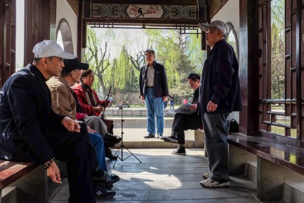 Beijing, China - April 3, 2014 - A choir from retired people practise singing in Tuanjiehu park.