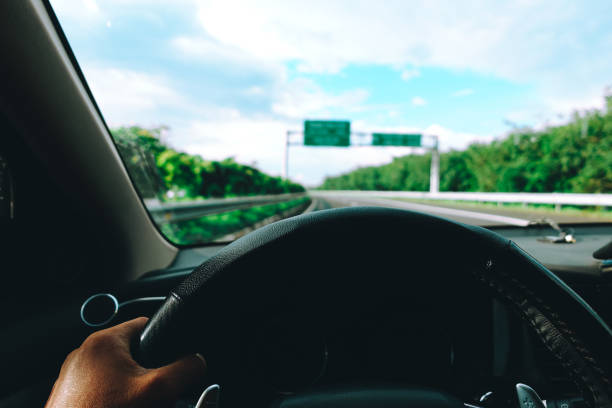 istock Hands of a driver on steering wheel, summer trip or vacation 1166725329