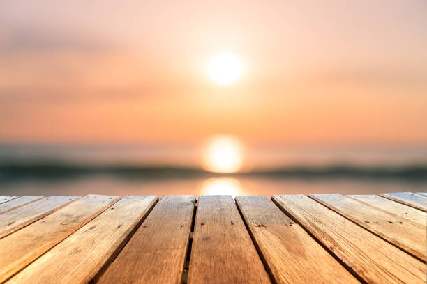 istock Selective focus of old wood table with blur beautiful beach background for display your product. 1166725348