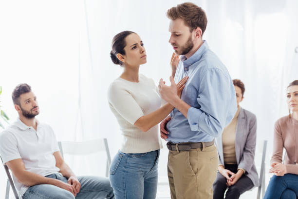 istock selective focus of woman consoling man during group therapy session 1166725362