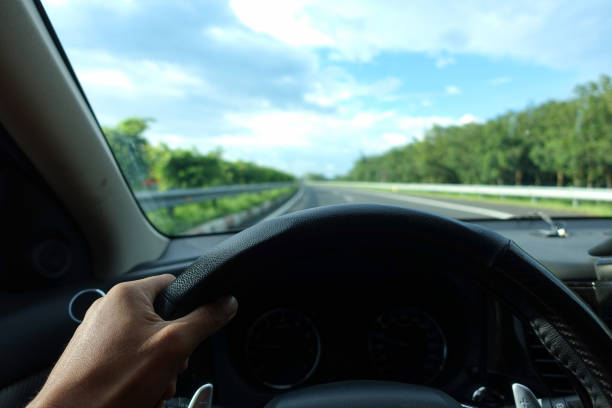 istock Hands of a driver on steering wheel, summer trip or vacation 1166725399