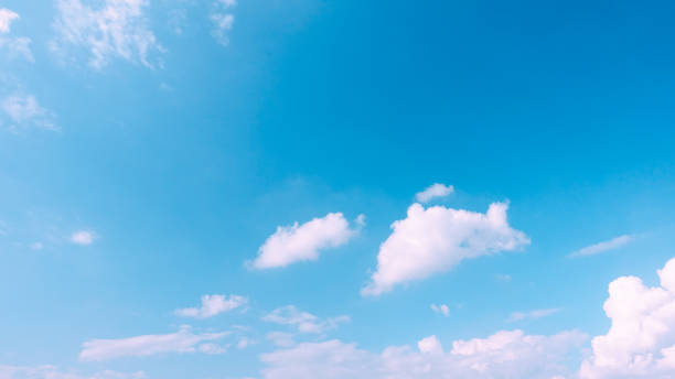 istock Beautiful bright blue sky with white fluffy clouds on a clear sunny day 1166725516
