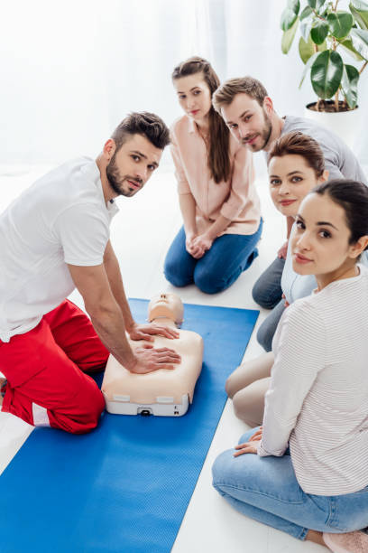 istock group of people with instructor looking at camera during first aid training 1166725531