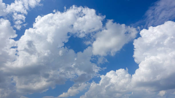 istock Beautiful bright blue sky with white fluffy clouds on a clear sunny day 1166725548