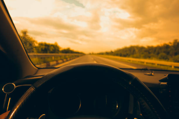istock Hands of a driver on steering wheel, summer trip or vacation 1166725597
