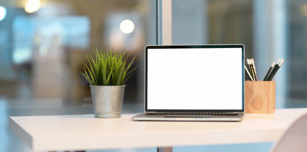 istock Open blank screen laptop with office supplies 1166728711