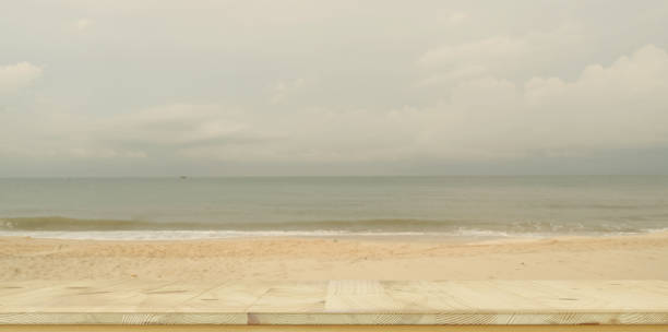 istock empty wooden desk and copy space with sea background 1166732103