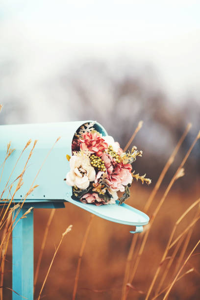istock Pastel teal mailbox with bouquet of flowers 1166732938