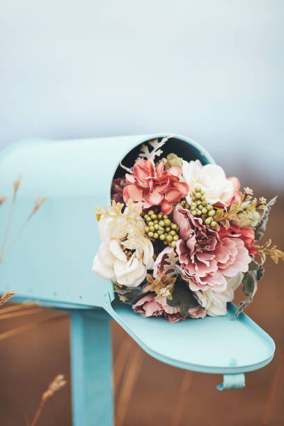 istock Pastel teal mailbox with bouquet of flowers 1166732963