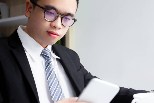 istock Asian businessman in coffee bar. 1166734202