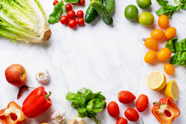istock Overhead image with healthy cooking ingredients on marble surface with copy space. Vegetarian cooking concept. Tomatoes, salad, basil and peppers. 1166735723