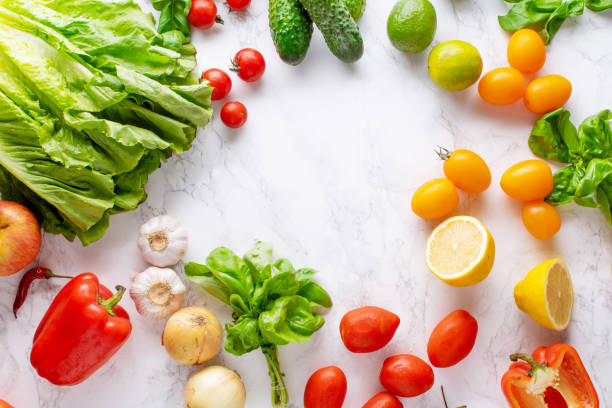 istock Overhead image with healthy cooking ingredients on marble surface with copy space. Vegetarian cooking concept. Tomatoes, salad, basil and peppers. 1166736407