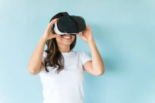 Photo of Happy Female Wearing Virtual Reality Headset Over Isolated Background