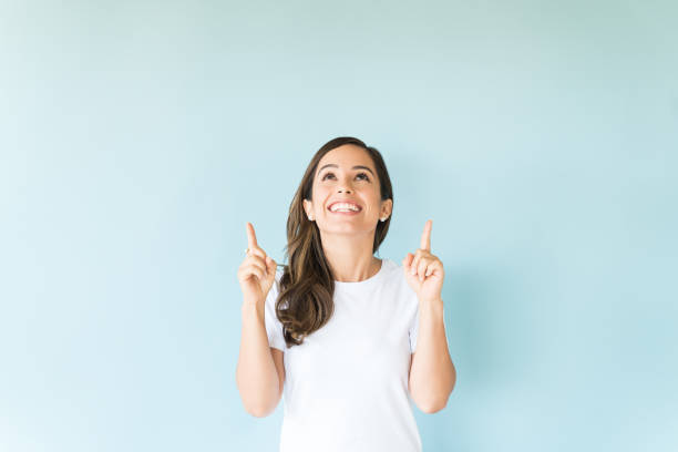 istock Caucasian Female Showing Empty Space In Studio 1166741433