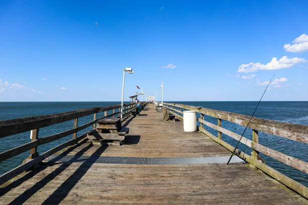 istock Lone Fishing Pole on Ocean View Pier 1166744625