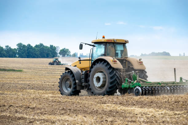 istock Tractor cultivating the field 1166744892