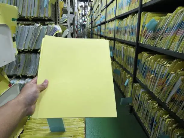 Man hand holding Document control room in hospital for important documents.Abstract.Data file.
Important file.Important file.Patient history.Medical records.Copy Space.